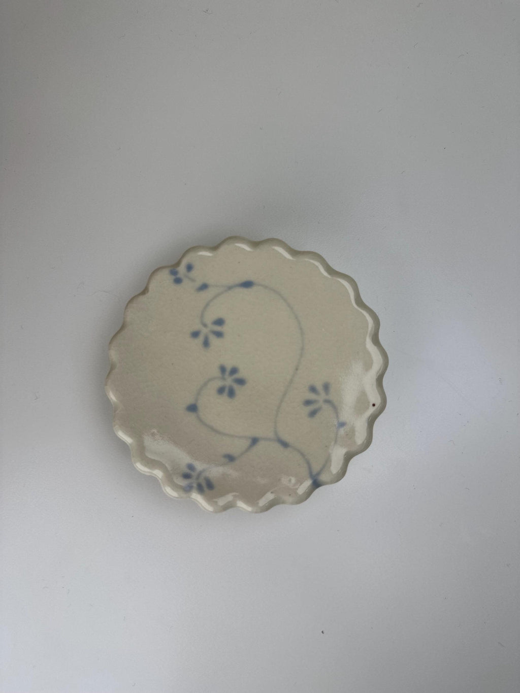 Handmade and hand painted pottery trinket dish, with handpainted blue underglaze and finished in a clear glaze, 3” with foot