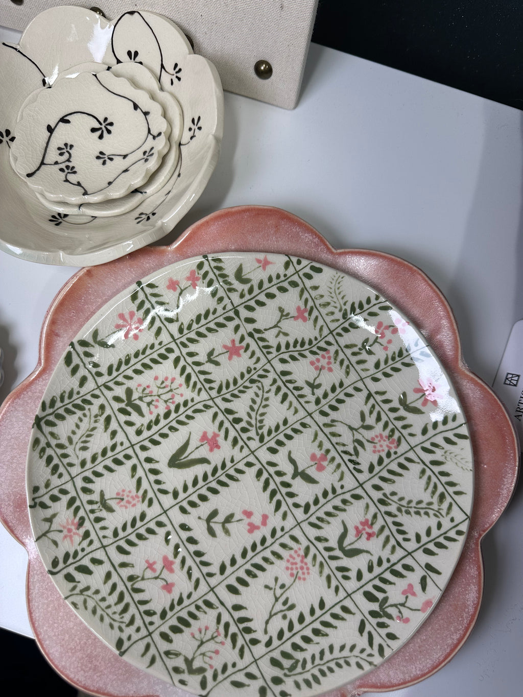 Decorative ceramic plate with floral pattern on a white surface