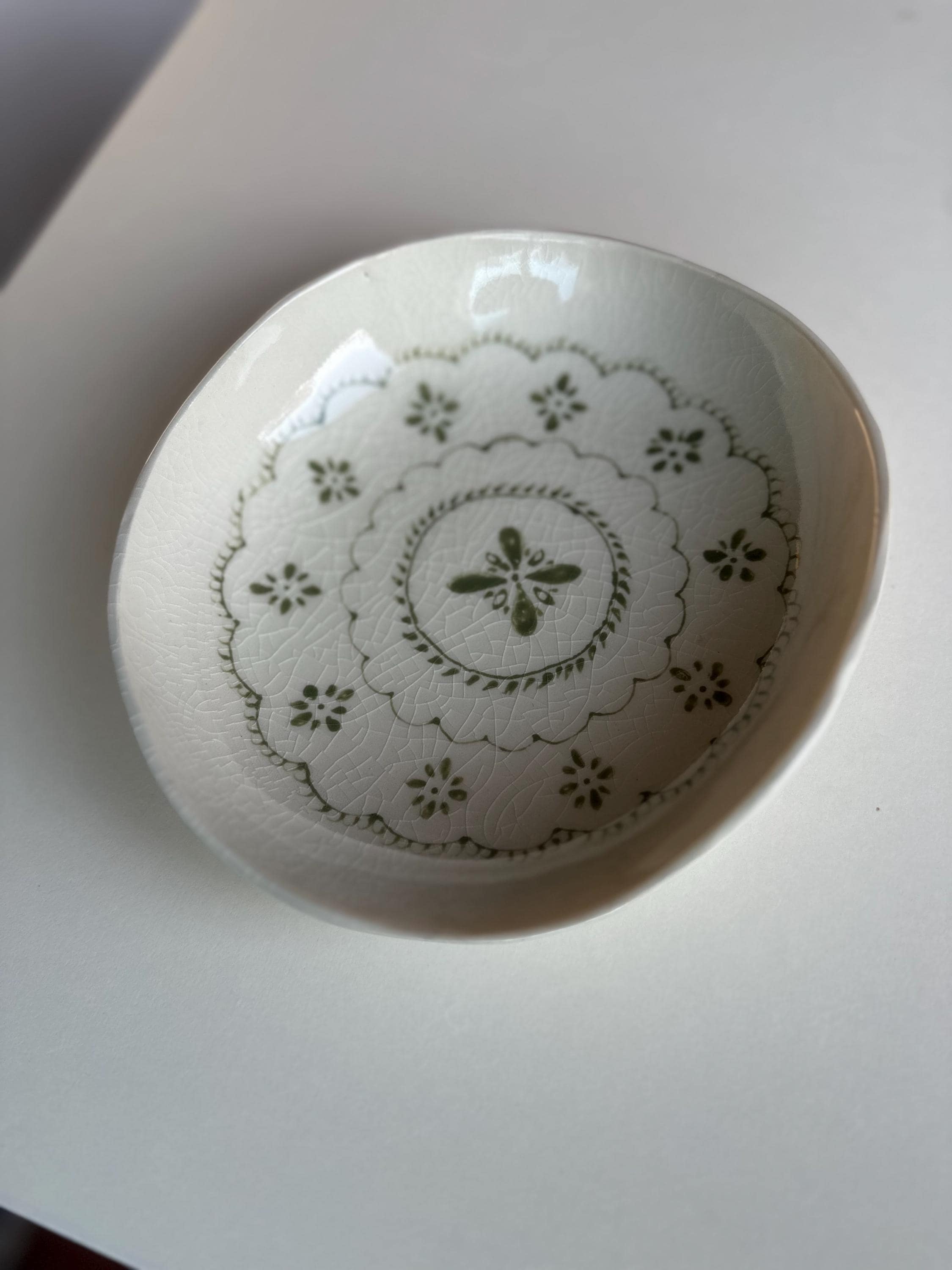 Handmade and hand painted pottery bowl,  with handpainted green underglaze and finished in a clear glaze, 7”