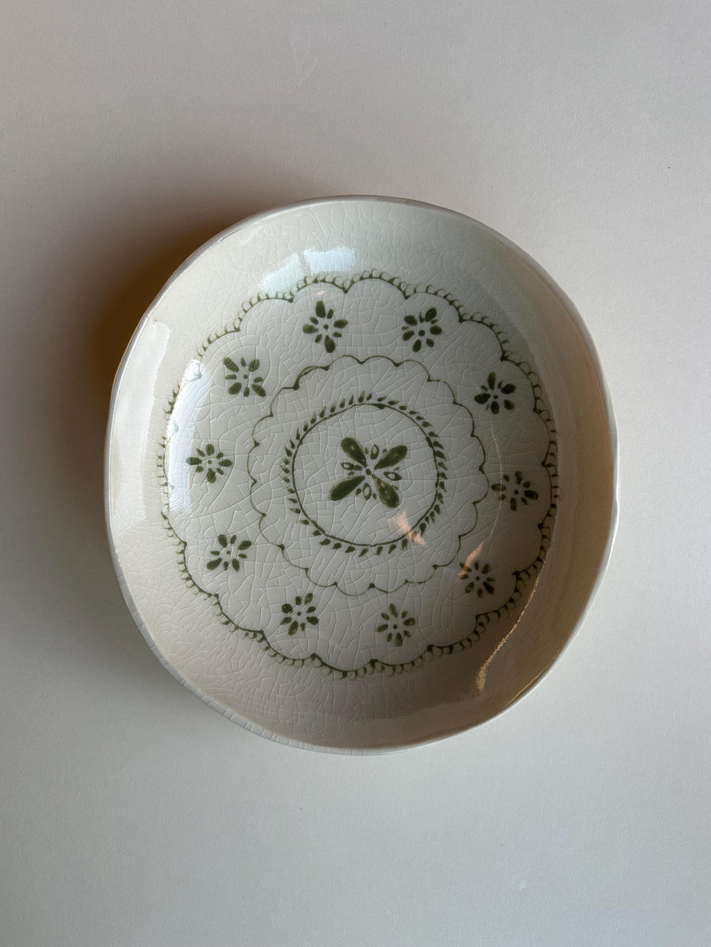 Handmade and hand painted pottery bowl,  with handpainted green underglaze and finished in a clear glaze, 7”